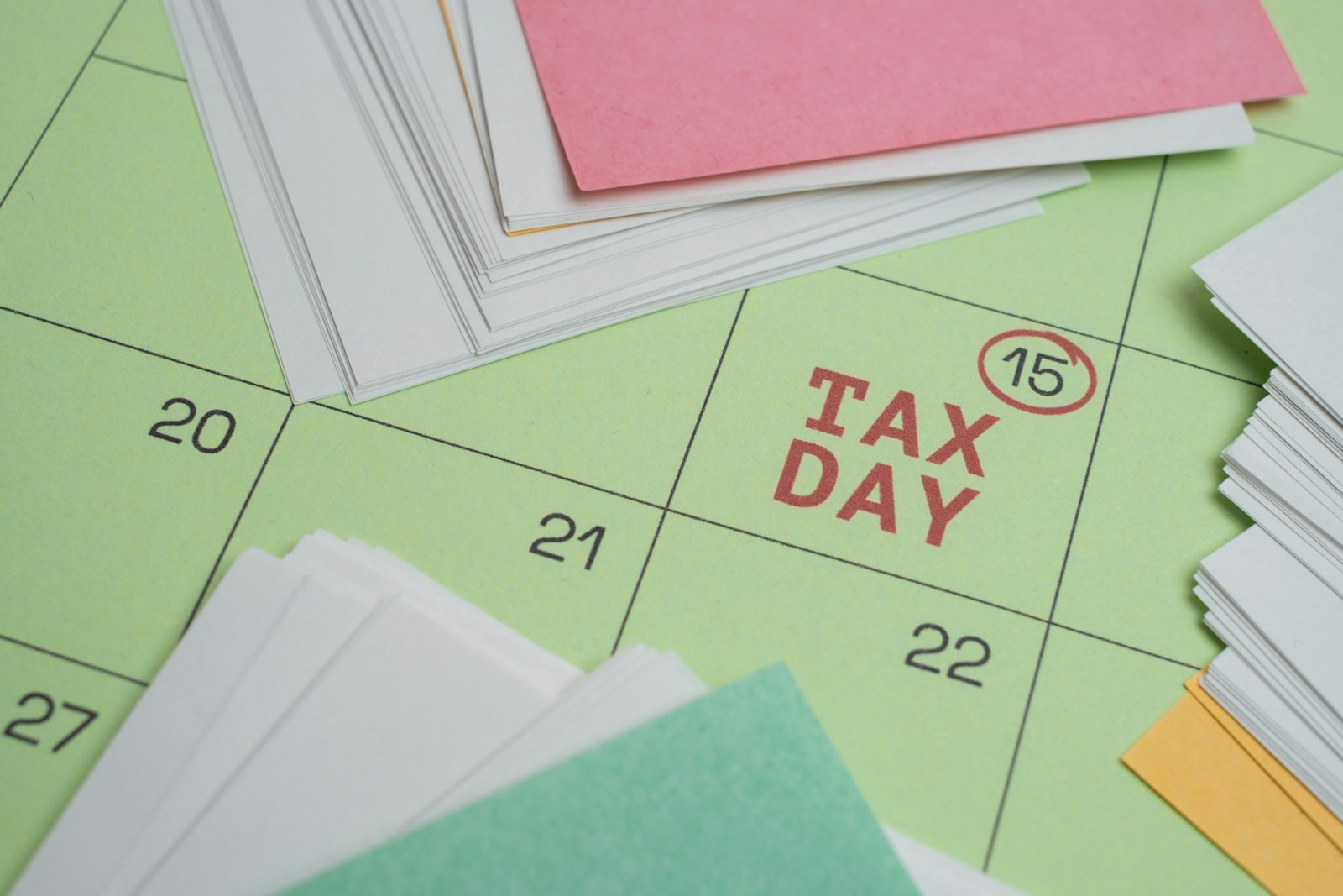 Calendar marking a financial deadline beside paperwork