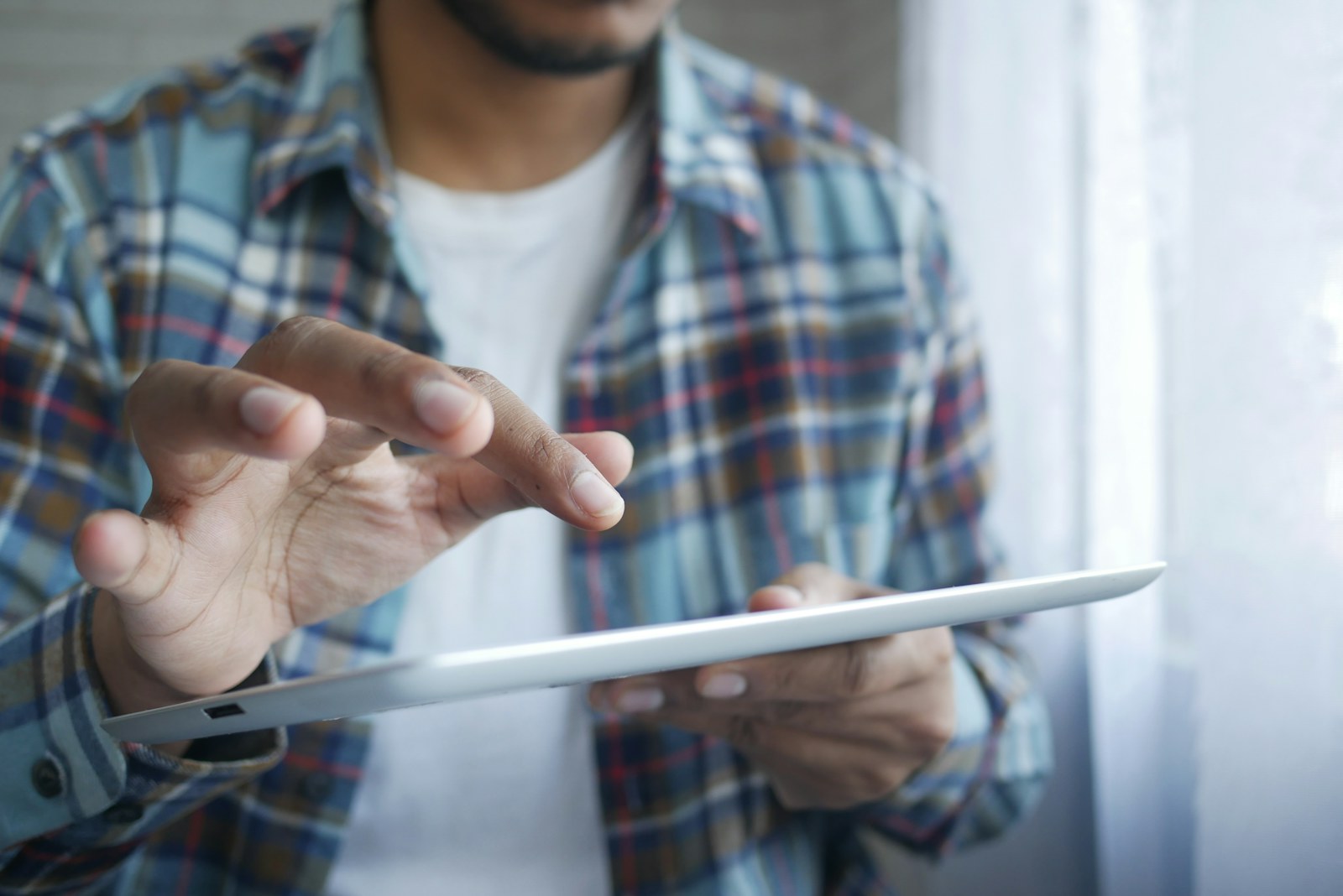 Person examining figures on a digital tablet