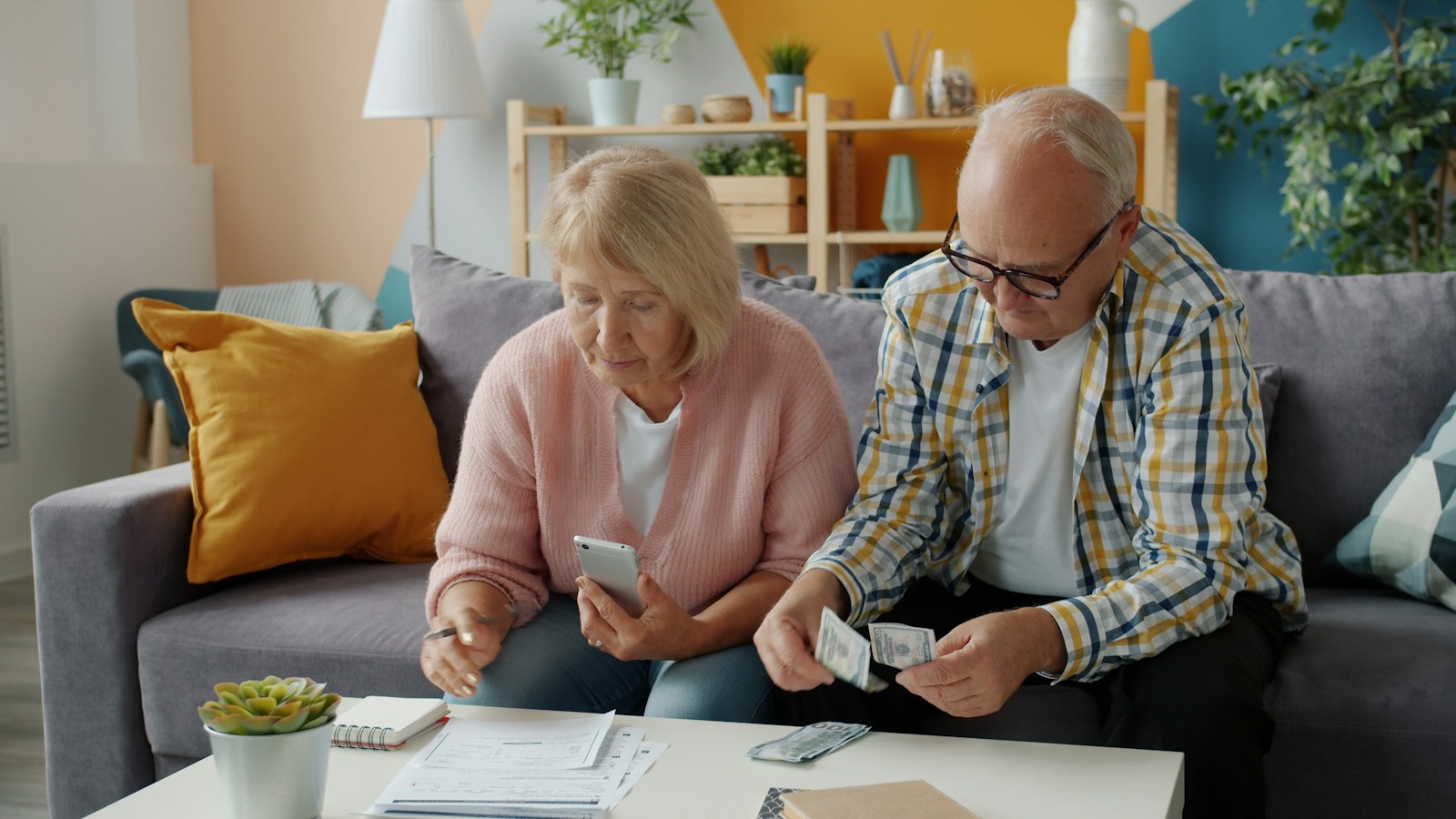 A couple reviewing financial papers and a phone together