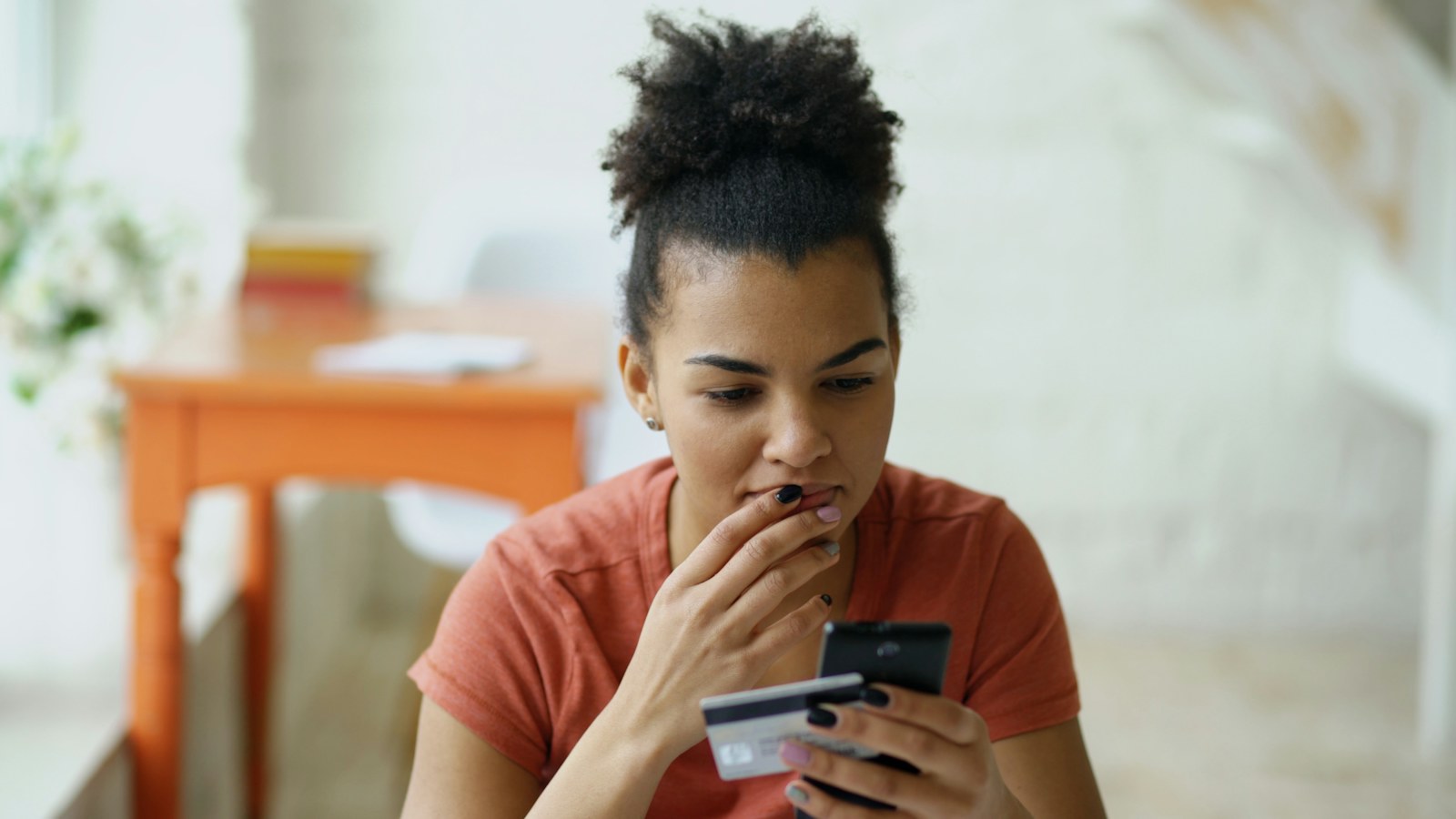 Person using a phone and a credit card